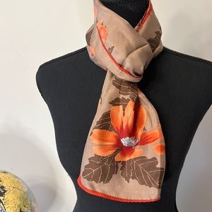Pretty scarf in fall colors. This fabric is polyester and the size is 11.5” x
